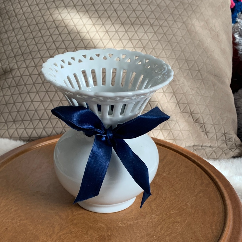 Mikasa Bridal Lace vase with blue ribbon made of white glazed porcelain.